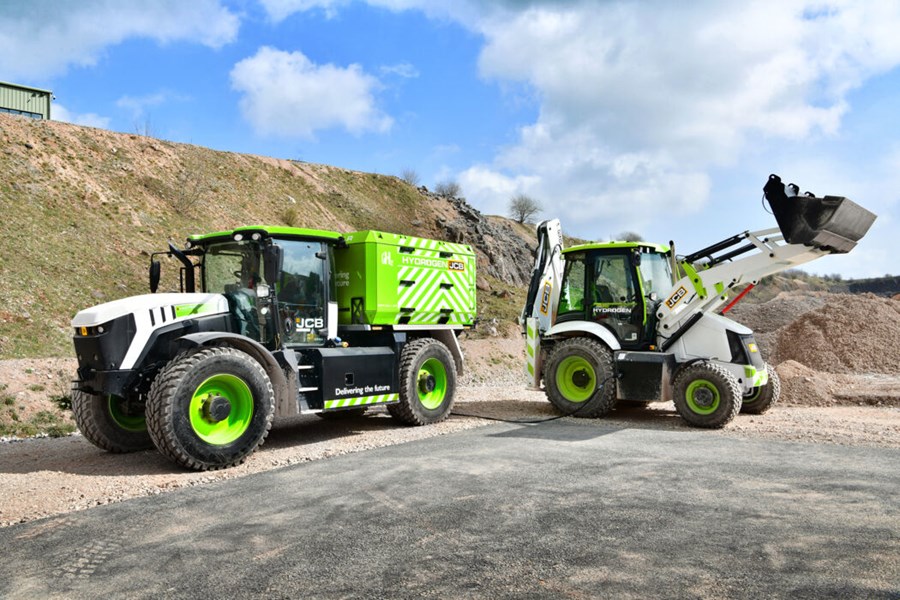 A JCB hydrogen excavator refuelling from a hydrogen transporter 