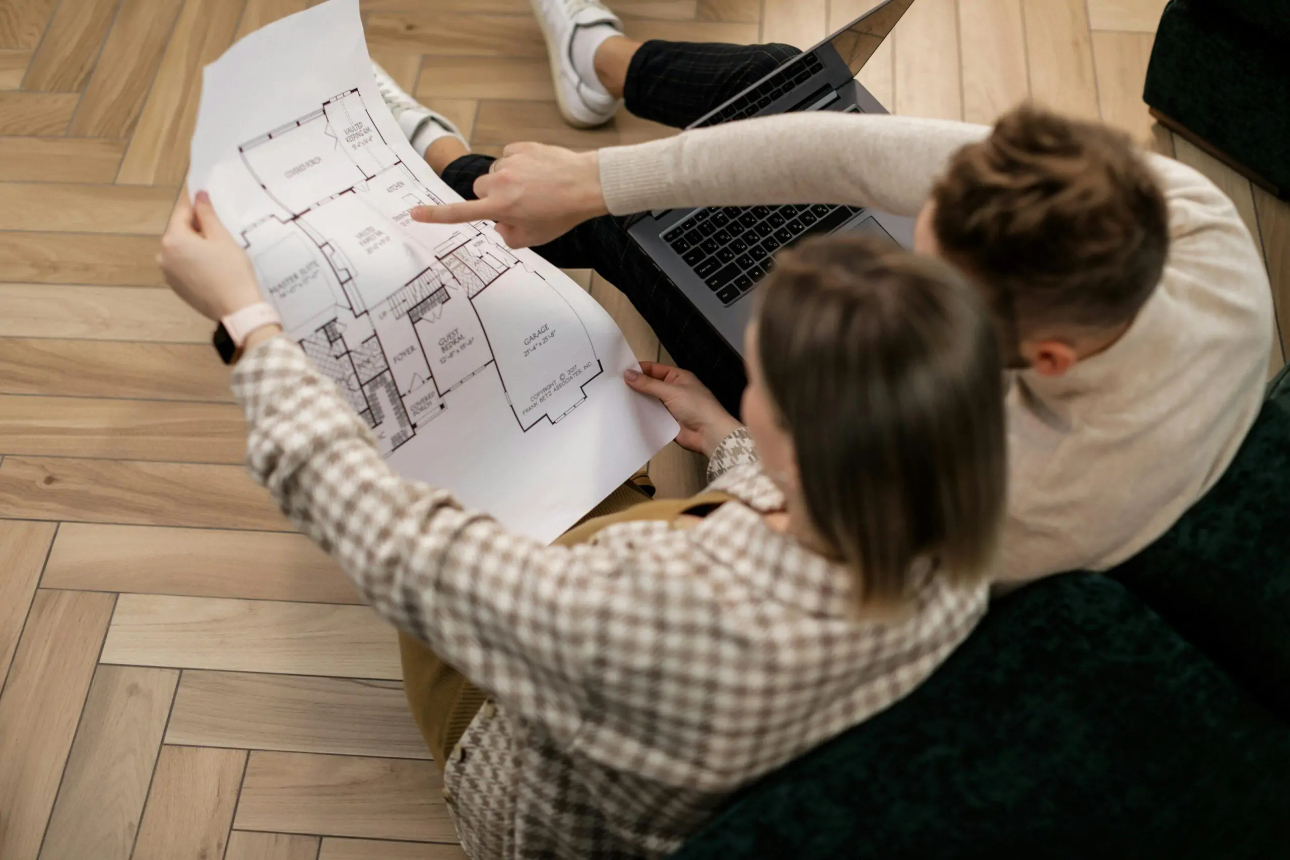 A couple examines a house blueprint together, exploring future home possibilities. How to build a house in Kenya 