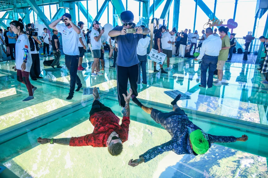 Tourists on the skydeck of the world's tallest bridge: the Huajiang Grand canyon bridge