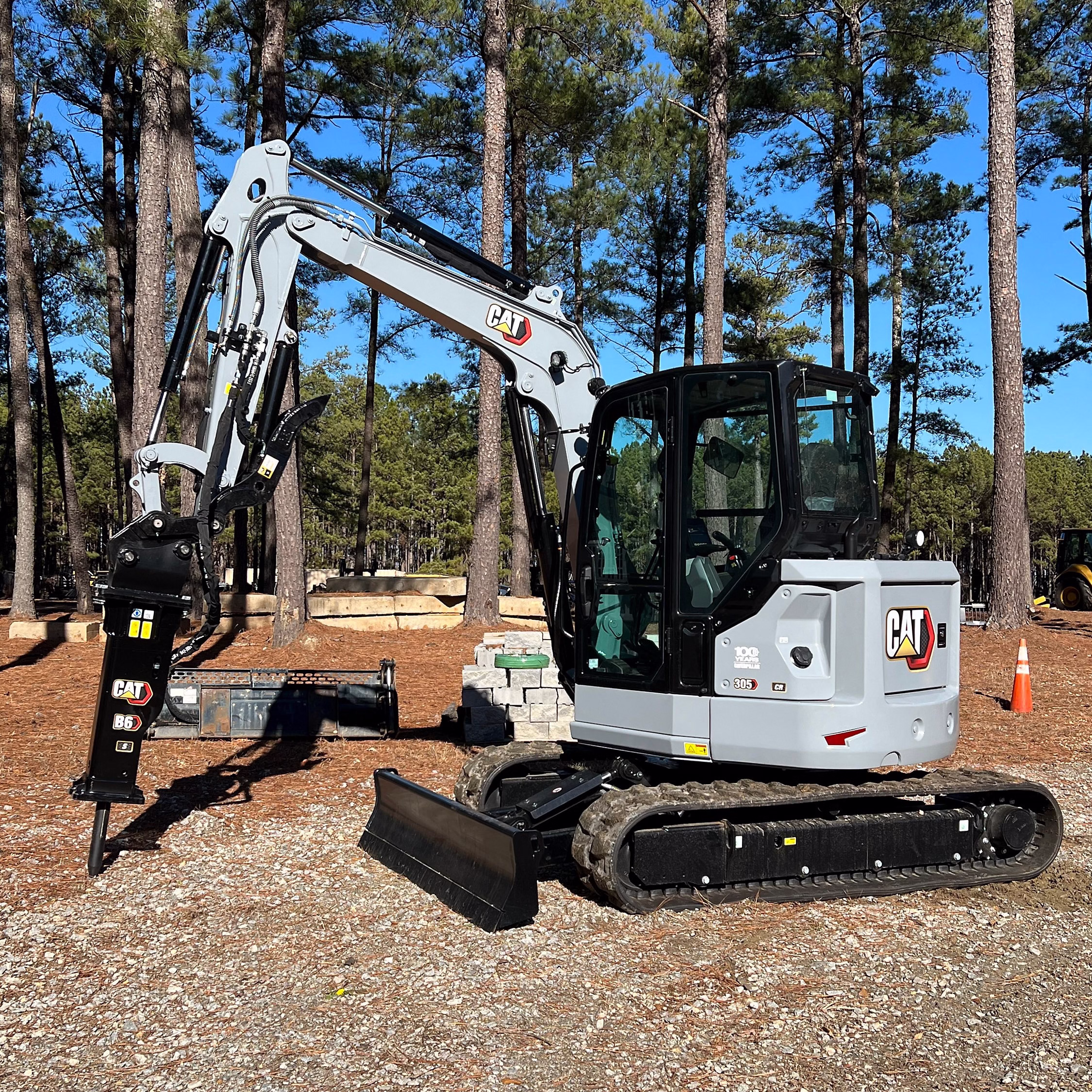 Caterpillar Marks 100-Year Anniversary: a mini-excavator with a pneumatic rock breaker