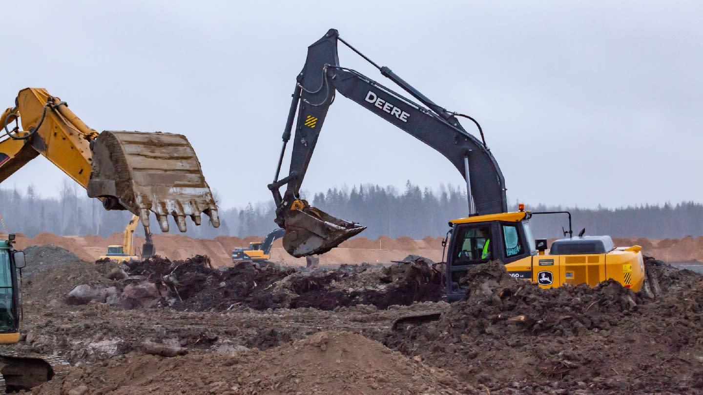 John Deere excavators working on a construction site