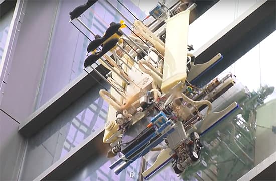 A window-cleaning robot in operation on a skyscraper.