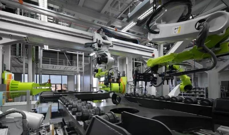 Zoomlion AI robots with robotic arms in operation at the Zoomlion smart excavator factory.