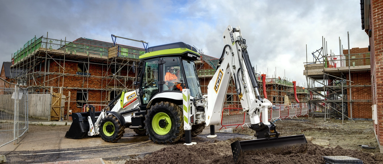 A JCB backhoe tractor in operation using hydrogen fuel for propulsion.