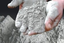 Africa's Cement Market. A person holding cement in their hands.