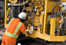 Construction Equipment Maintenance: A technician performing repairs on a CAT excavator.