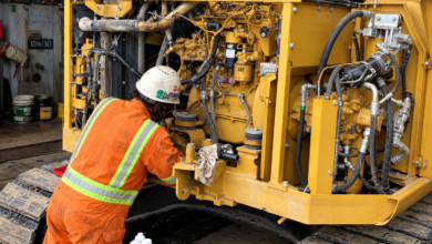 Construction Equipment Maintenance: A technician performing repairs on a CAT excavator.